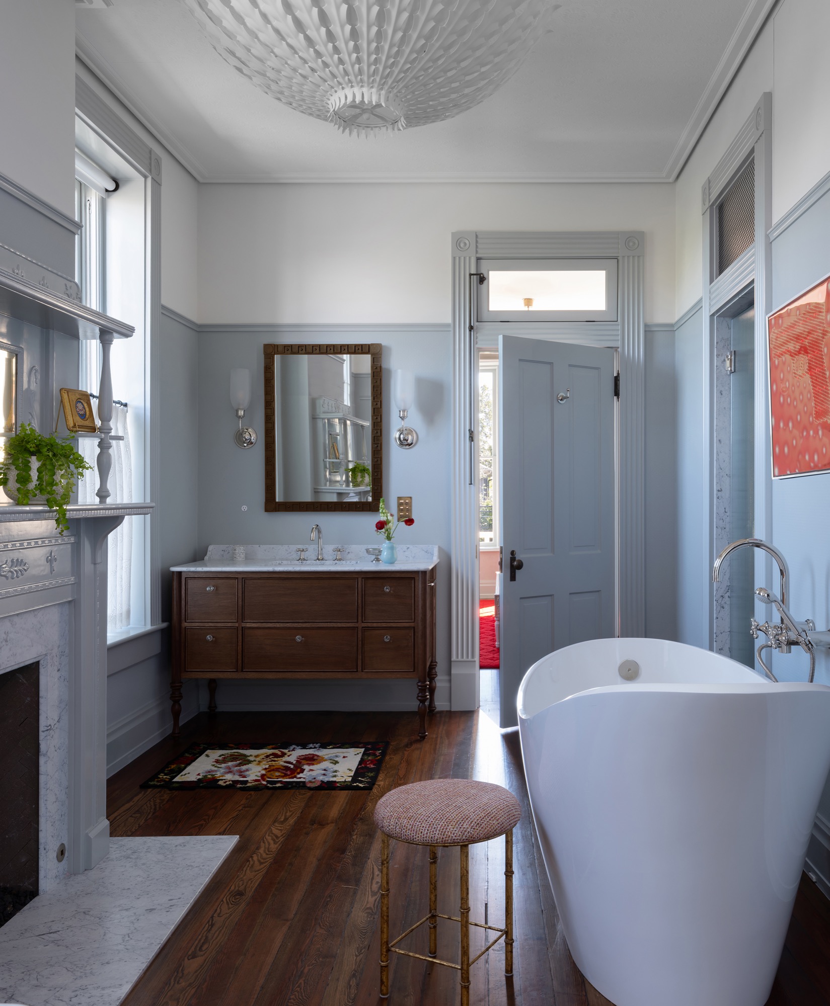 Victorian House bathroom with freestanding tub and fireplace in Austin, Texas